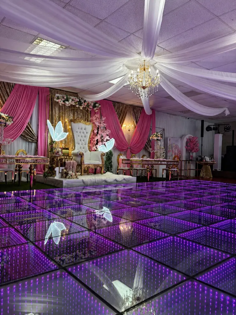 Purple infinity LED floor leading to a floral Quinceañera throne backdrop