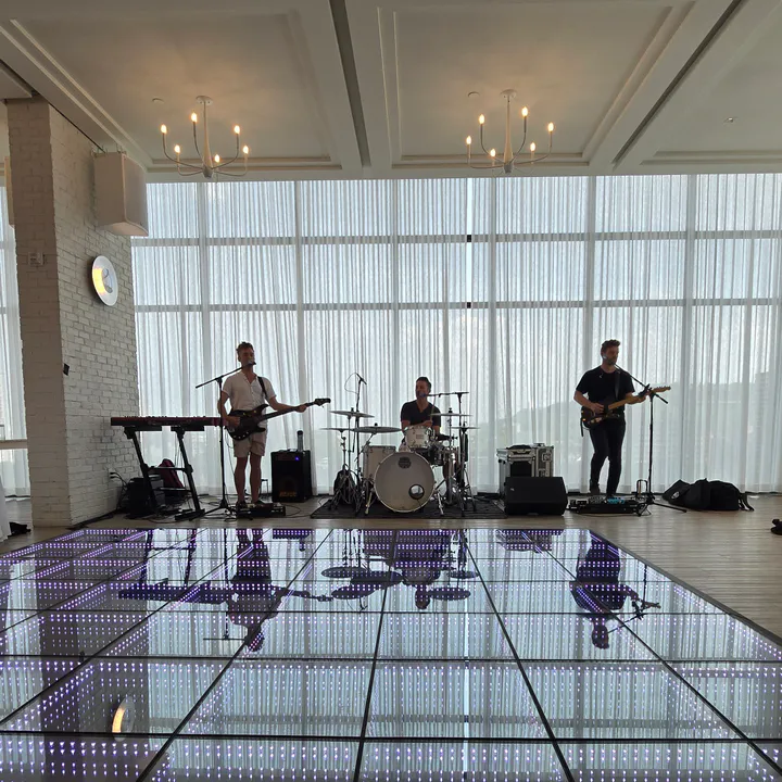 Live band reflected across an infinity LED floor at a Jersey City wedding