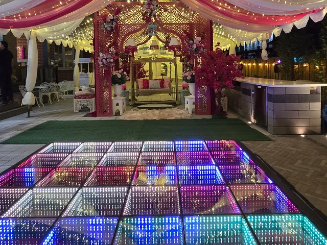 Decorated tent celebration with a full-color infinity LED dance floor