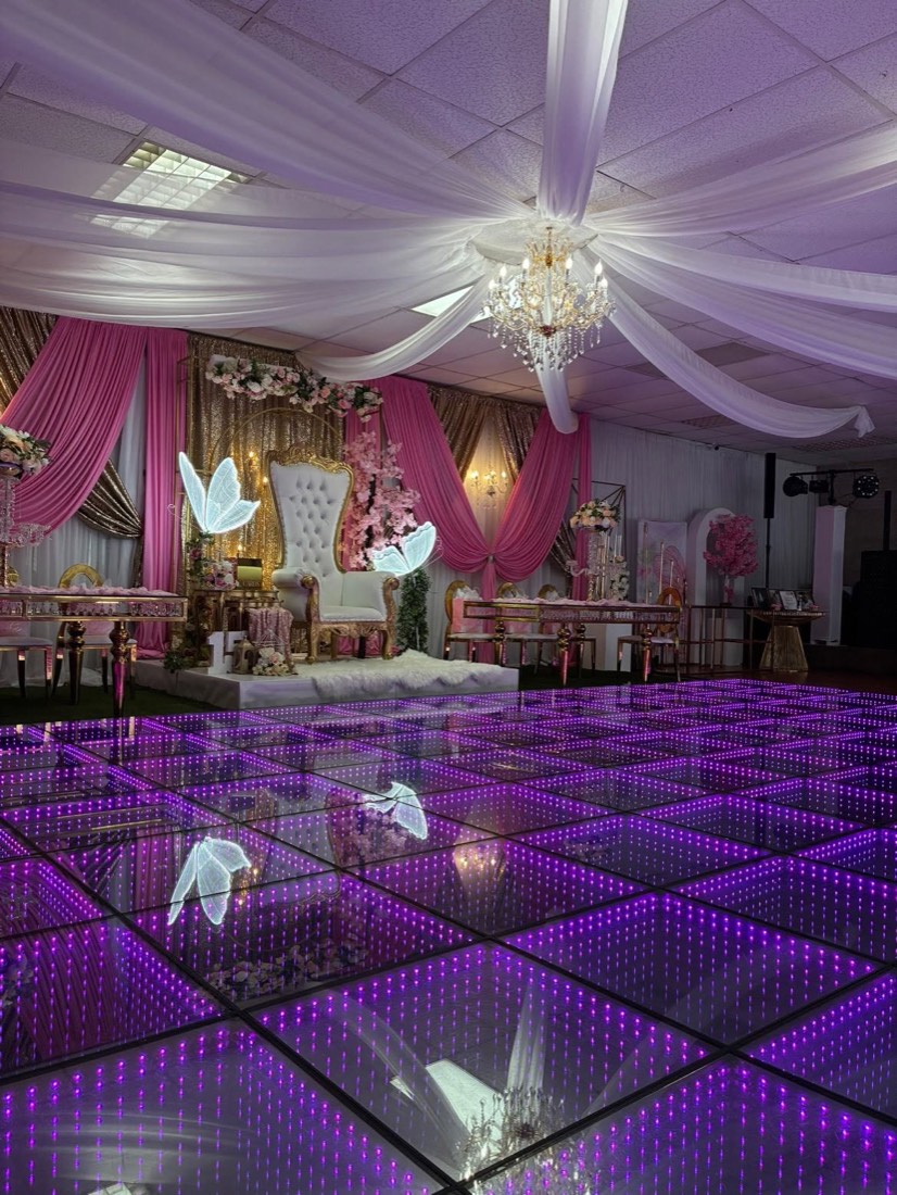 Purple infinity LED dance floor at a draped quinceañera with chandelier and throne